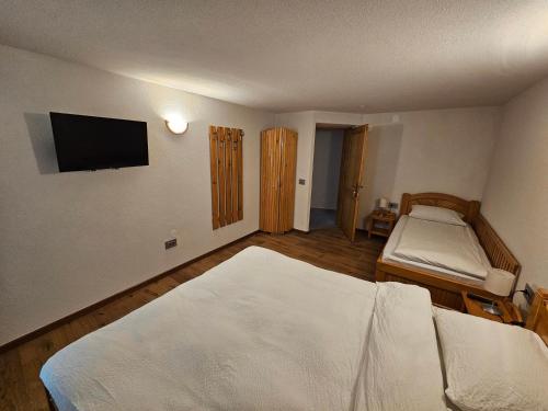 a bedroom with two beds and a flat screen tv at Casa Miorita in Cumpăna