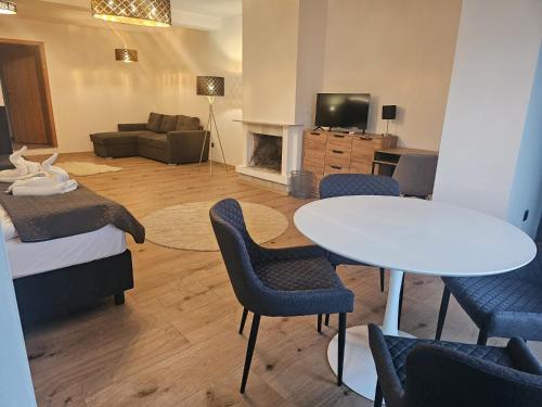 a room with a bed and a table and chairs at PENZION BLANKA - Znojmo in Znojmo
