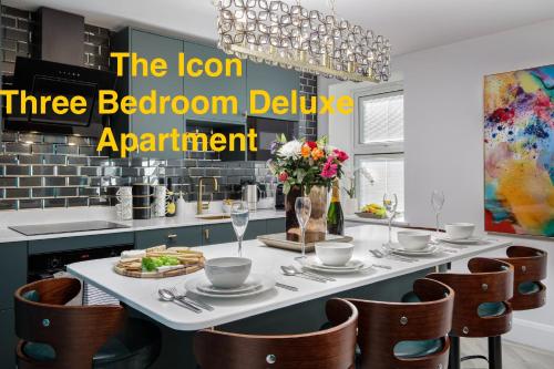 a dining room with a table with plates and glasses at Swish Luxury Holiday Apartments in Blackpool