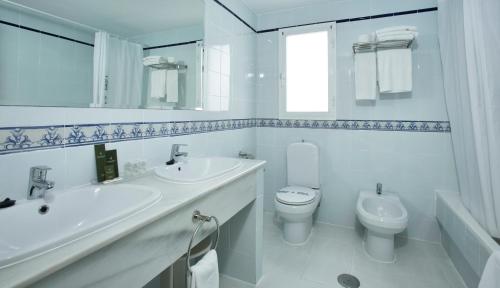 a white bathroom with a sink and a toilet at Ona Campanario in La Cala de Mijas