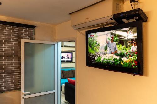 a flat screen tv hanging on a wall at דירות נופש אברהם in Eilat