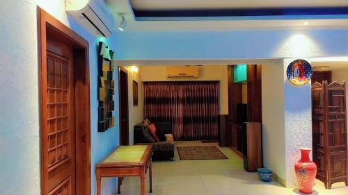 a hallway leading to a living room with a table at Luxury Furnished Apartment in Dhaka