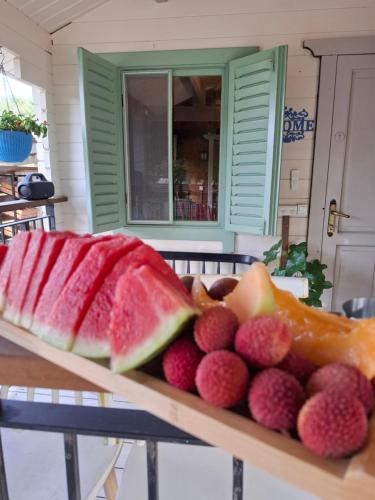 a plate of fruit sitting on a table at הבקתה של רינת in Me‘ona