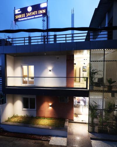 a night view of a building with a sign on it at Shree Jayati Inn in Ayodhya