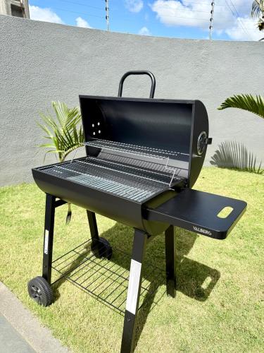 a bbq grill sitting in the grass at MoonLight Residence in Pointe aux Piments