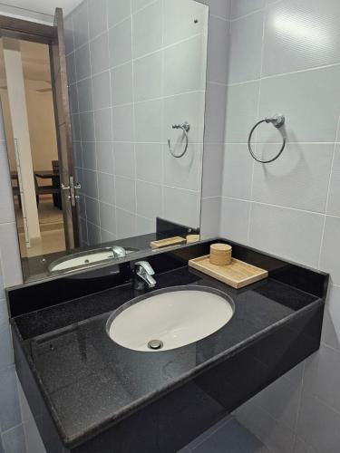 a bathroom with a sink and a mirror at Appartment 710 - Zahrat Al Khareef in Salalah