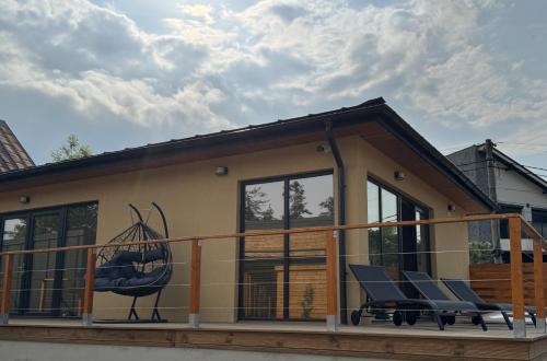 a house with two chairs on a balcony at A-Frame Valley in Buşteni