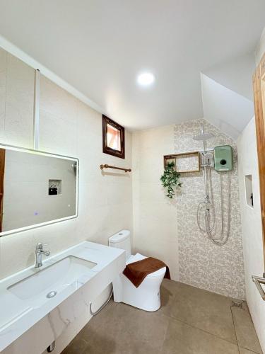 a white bathroom with a sink and a shower at 549 Resort & Cafe Lamphun in Ban Mae Pok