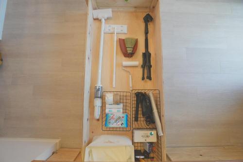 a room with a wall with a rack with tools at Ocean Front! Simple Resort YAKA in Kin