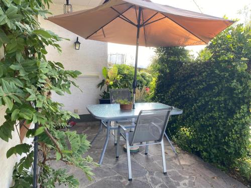 a table and chairs with an umbrella on a patio at FeWo Marielle in Seeboden