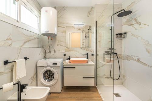 a bathroom with a washing machine and a shower at Panarea Chaparal in Costa Del Silencio