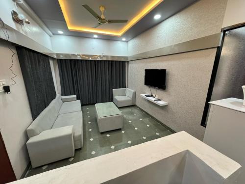 a bathroom with a ceiling fan and a tv at Satyabhama Homestay - Tulip - Two BHK luxury apartment in Indore