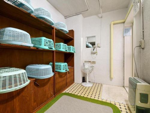 a room with blue dishes on shelves in a room at Sports Plaza Shirakaba in Tokamachi