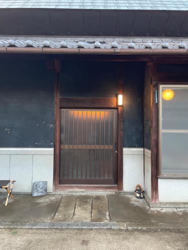 a front door of a building with a wooden gate at dannouraしげの里 1棟貸切 築120年古民家 バーベキュー 海が見える in Takamatsu