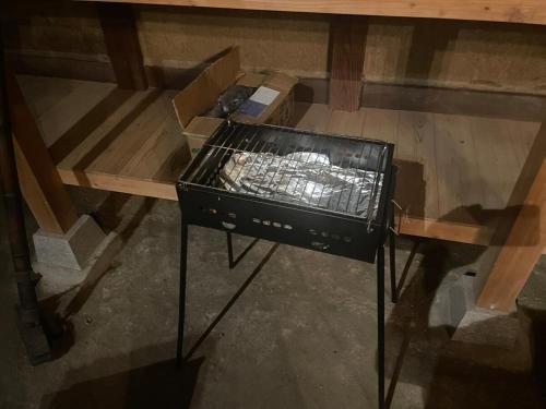 a stove sitting on top of a wooden table at dannouraしげの里 1棟貸切 築120年古民家 バーベキュー 海が見える in Takamatsu