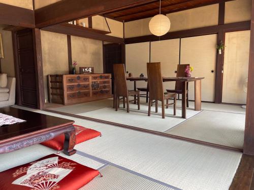 a dining room with a table and chairs at dannouraしげの里 1棟貸切 築120年古民家 バーベキュー 海が見える in Takamatsu
