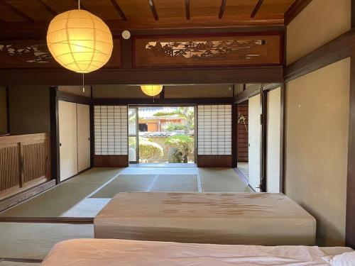 a room with two beds and two lanterns at dannouraしげの里 1棟貸切 築120年古民家 バーベキュー 海が見える in Takamatsu