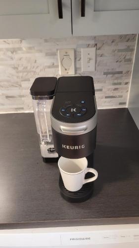 a coffee maker on a counter with a cup of coffee at Centrally Located Southside Private Basement Suite in Lethbridge