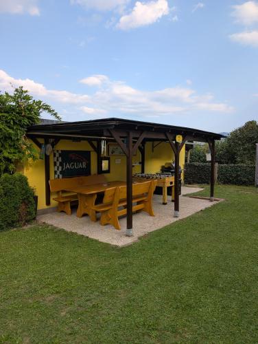 a picnic shelter with benches in a park at Harti Haus in Zeltweg