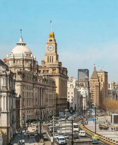 a city with a clock tower on top of a building at Jinglai Hotel Light Luxury - Daning International Shanghai Business School Branch in Shanghai