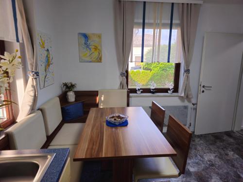 a dining room with a table and a sink at Harti Haus in Zeltweg