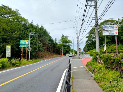 an empty road with a sign on the side at Ondolphin in Narusawa