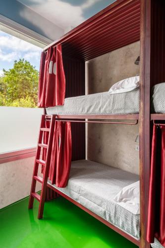 a bunk bed in a room with a ladder at Blanco Albergue in Santiago de Compostela