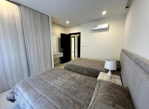 a hotel room with two beds and a couch at The view in Māḩiş