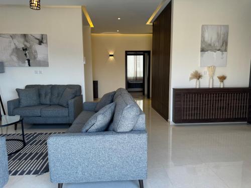 a living room with two chairs and a couch at The view in Māḩiş