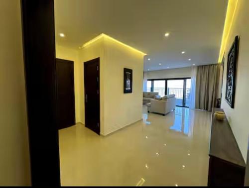 a large living room with a couch and a living room at The view in Māḩiş