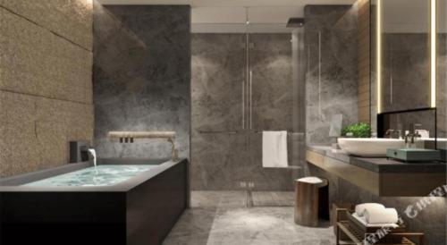 a bathroom with a tub and a sink at Empark Grand Hotel Fuzhou in Fuzhou