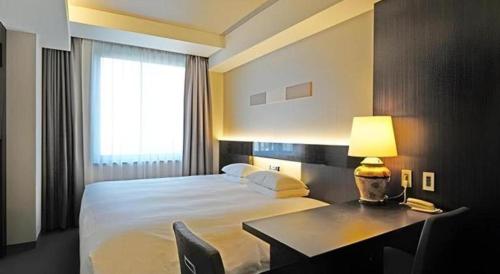 Hotel Riverge Akebonoにあるベッド