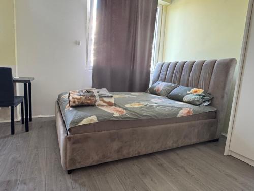 a bed sitting in a room with a couch at RS Apartmani in Belgrade