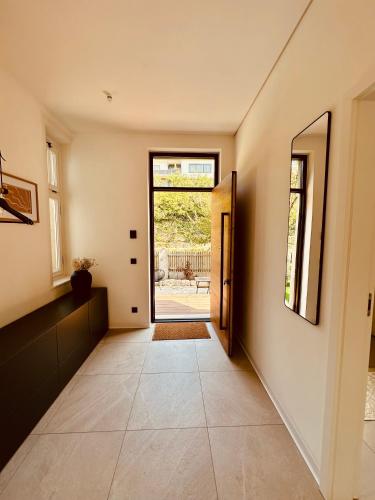 a hallway with a door leading to a patio at luxuriöse Altbau Wohnung in Denkmal-Villa in Aidlingen