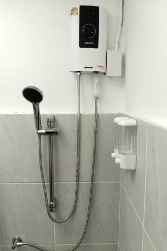 a shower in a bathroom with aperature at PaiPaiHostel in Pai