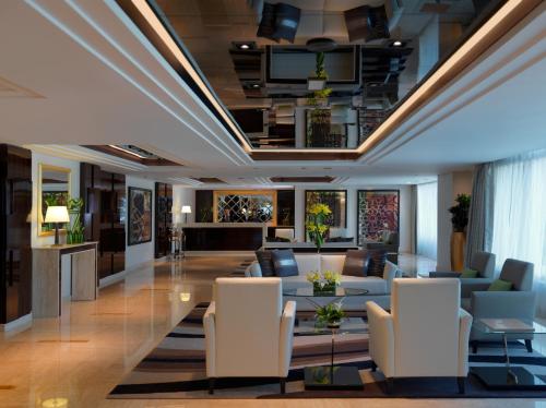 a lobby of a hotel with couches and chairs at DAMAC Maison Canal Views in Dubai