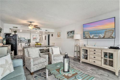 a living room with a couch and chairs and a tv at 1201 Waters Edge Resort in Myrtle Beach
