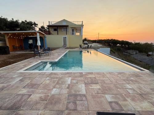 a swimming pool in front of a house at Rose Villa in Agios Stefanos