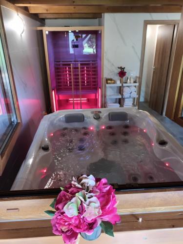 a large bath tub with a flower in the middle at Vila Carmen kuća za odmor sa wellnessom,Sunger in Mrkopalj