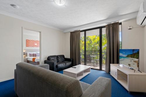a living room with a couch and a tv at Turtle Beach 250 in Gold Coast