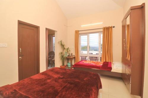 a large bedroom with a bed and a window at HIGHLAND Hills in Coonoor