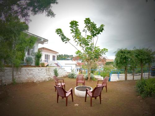 a group of chairs sitting in a yard at HIGHLAND Hills in Coonoor