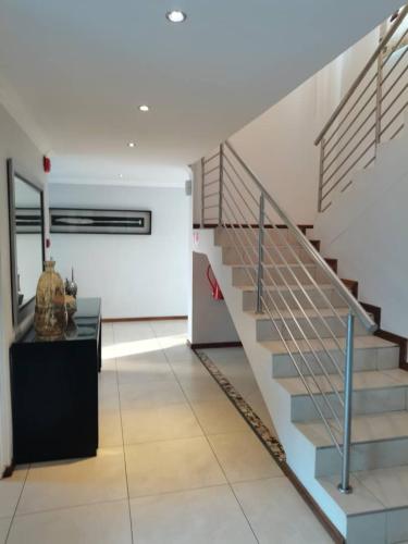 a hallway with a staircase in a building at Kgale Lodge in Gaborone