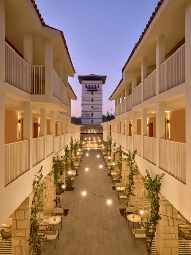 a corridor of a hotel with tables and chairs at Paloma Grida in Belek