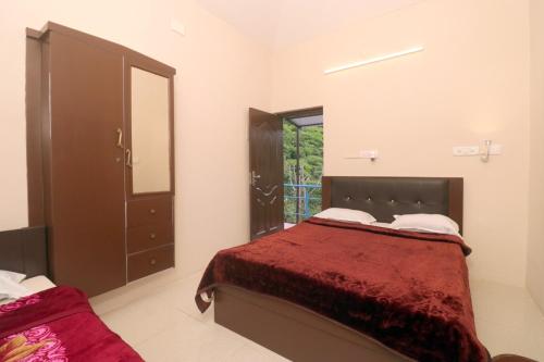 a bedroom with a bed and a large mirror at HIGHLAND Hills in Coonoor