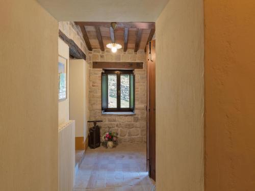 a hallway of a home with a brick wall at Gorgeous Apartment with Pool near Sibillini Mountains in Monte San Martino