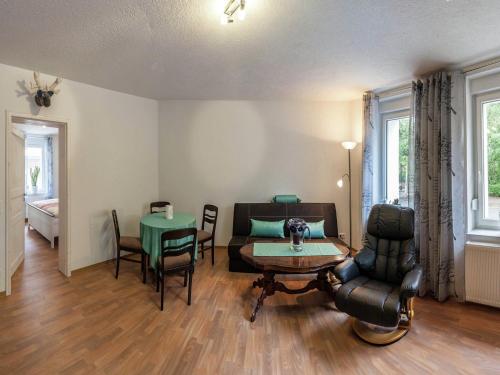a living room with a table and a couch at Bright apartment in Thale with terrace in Thale