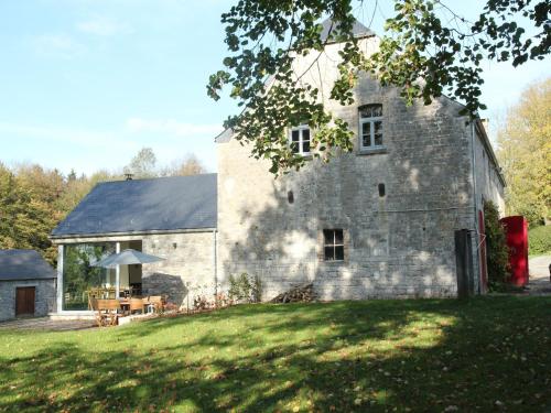 a large stone building with a table in front of it at Gite with swimming pool situated in wonderful castle grounds in Gesves in Gesves