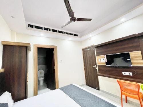 a bedroom with a bed and a flat screen tv at Hotel Premium LAXMIVILLAS ! Varanasi, Near Kashi Vishwanath Temple And Railway station, Fully Air conditioned & Spacious Room - Prime Location wifi- Lift and Room Service Facilities, BEST HOTEL IN VARANASI in Varanasi