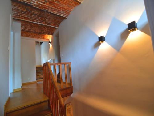 a hallway with two lights on the wall at Gite with swimming pool situated in wonderful castle grounds in Gesves in Gesves